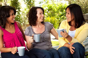 Nice women talking outside in chairs