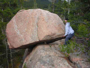 Lifting a heavy rock on a moutain side