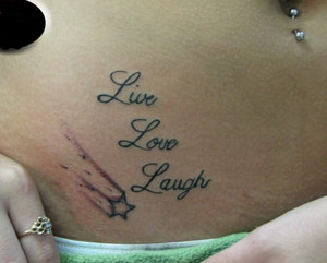 Live love laugh tattoo on girl's belly
