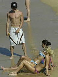 Man scratching his balls on the beach