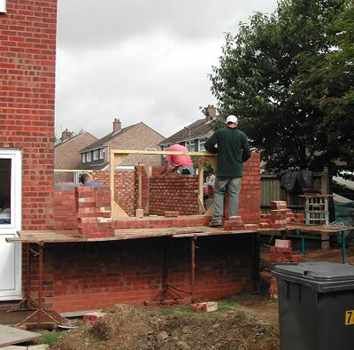 Man lays brick