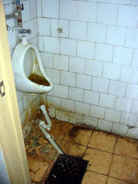 Gross urinal in a men's restroom