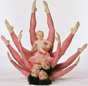 Women in pink tights lying on top of each other to make a vagina shape
