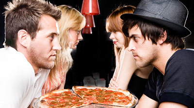 Two guys sharing a pizza