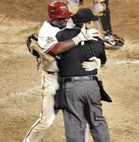 Baseball player hugs umpire