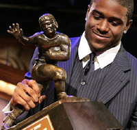 Reggie Bush holding Heisman Trophy