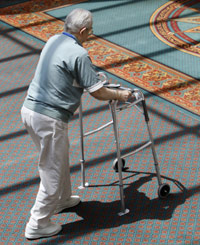 Old man walking through a retirement cottage courtyard