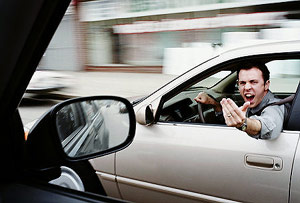 Man shouting out of a car window angry mad