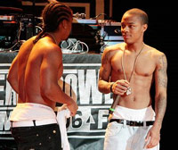 Two black guys sizing each other up on stage
