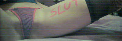 Slutty girl with 'slut' written in marker on her leg by her thong