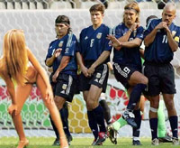 Guys in a soccer wall distracted by a naked woman on the pitch