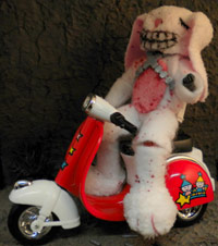 Pink teddy bear on a scooter