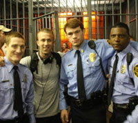 Tucker Max with film production crew and police actors