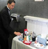 Bathroom attendant in a tux