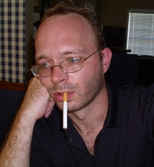 Wesley Jansen with sad face smoking cigarette
