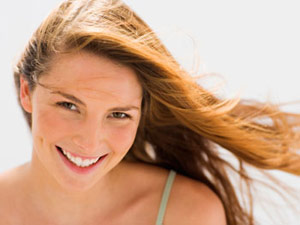 Woman with a big smile at a gas station