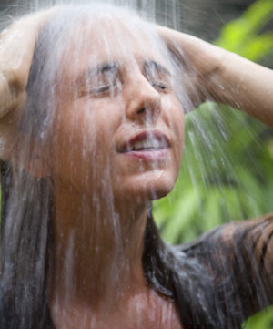 Woman under a shower head water
