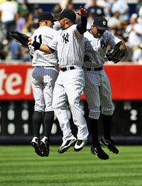 Yankees players celebrating in the outfield