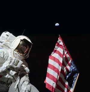 Astronaut holds a flag in space