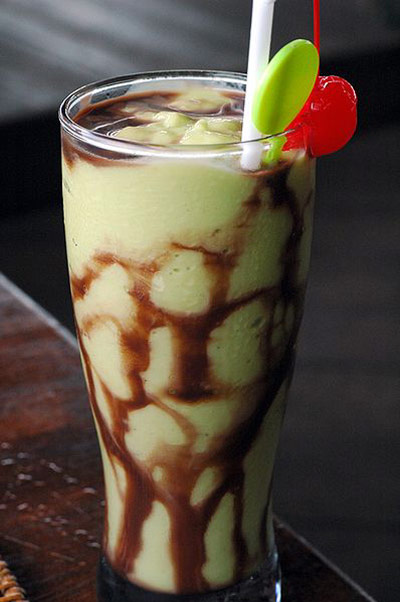 Avocado milkshake with a straw