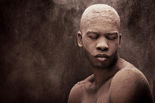 Man with chocolate powder dumped on his head