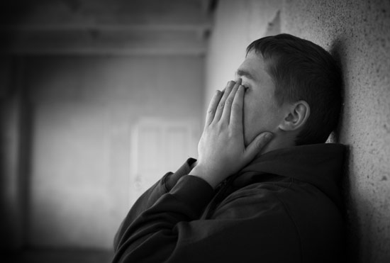 Man crying with regret hands on face