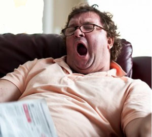 Man yawning on couch