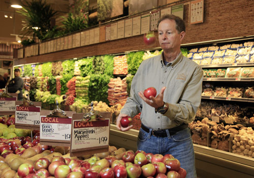Guy shopping for apples at Whole Foods