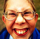 Homeschooled boy with nerdy grin