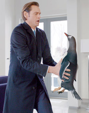 Jim Carrey holding a penguin in Mr. Popper's Penguins movie