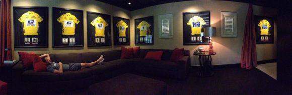 Lance Armstrong with his Tour de France jerseys at home