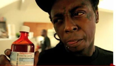 Lil Wayne with bottle of sizzyrup (codeine/promethazine)