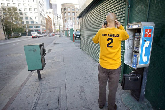 Man calling at a pay phone desperate