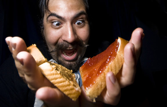 Scared man eating a peanut butter and jelly sandwich 