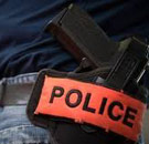 Gun in holster on officer's hip