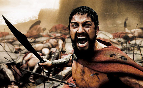 Hero raises sword in epic battle scene of 300 movie
