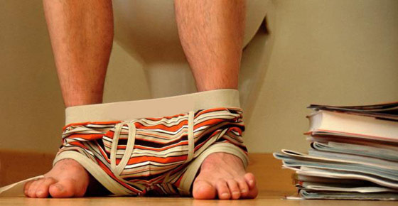 Man reading books on the toilet