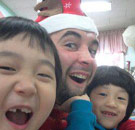 Casey Freeman wearing Santa hat with kids
