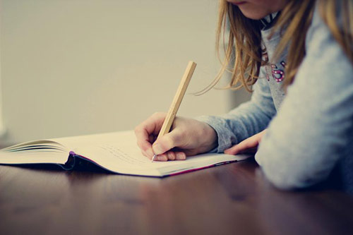 Sorority girl writing poetry in a notebook