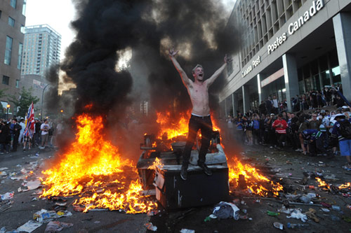 Street fire burning car protestor