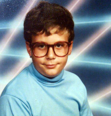 Middle school yearbook photo of nerdy boy