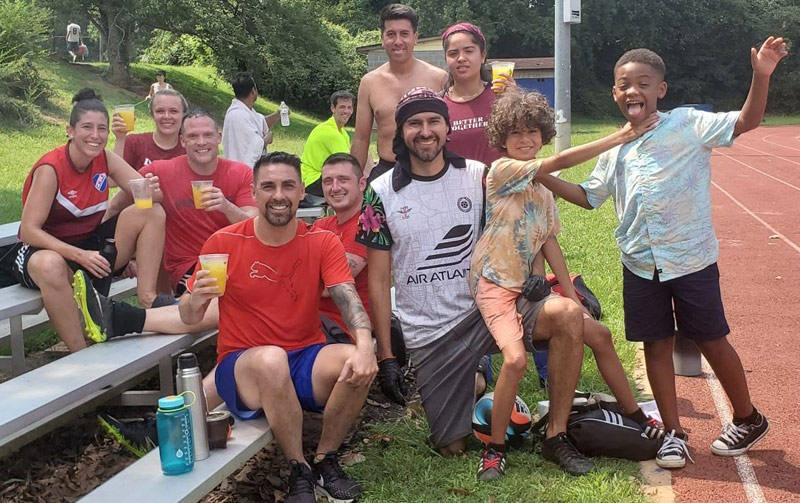 Mango Boys and players drinking virgin mango mojitos at the soccer field