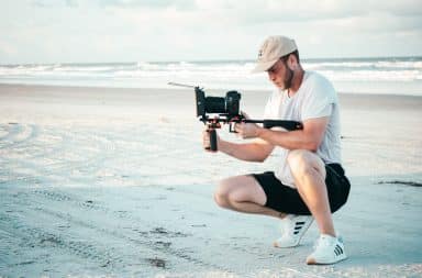 Man filming on the beach