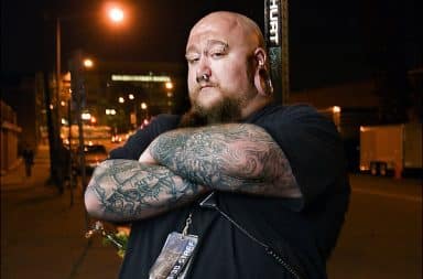 Tattooed bouncer outside a bar