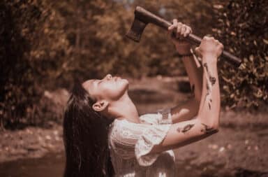 Woman holding an axe to her head