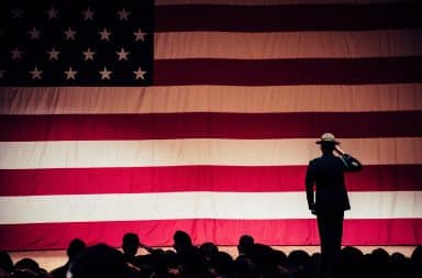 Man saluting USA flag after Cold War