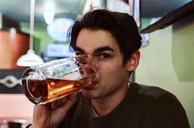 High-functioning alcoholic man drinking a beer