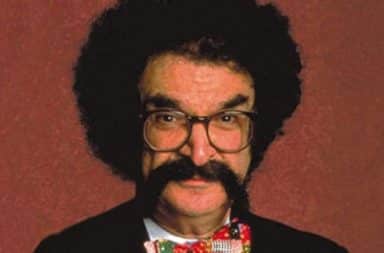 Gene Shalit with big hair and mustache