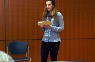 Girl reading poetry at a poetry reading event