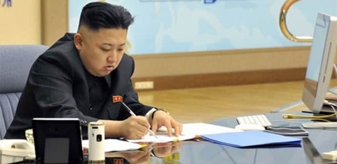 Kim Jong Un writing at a table